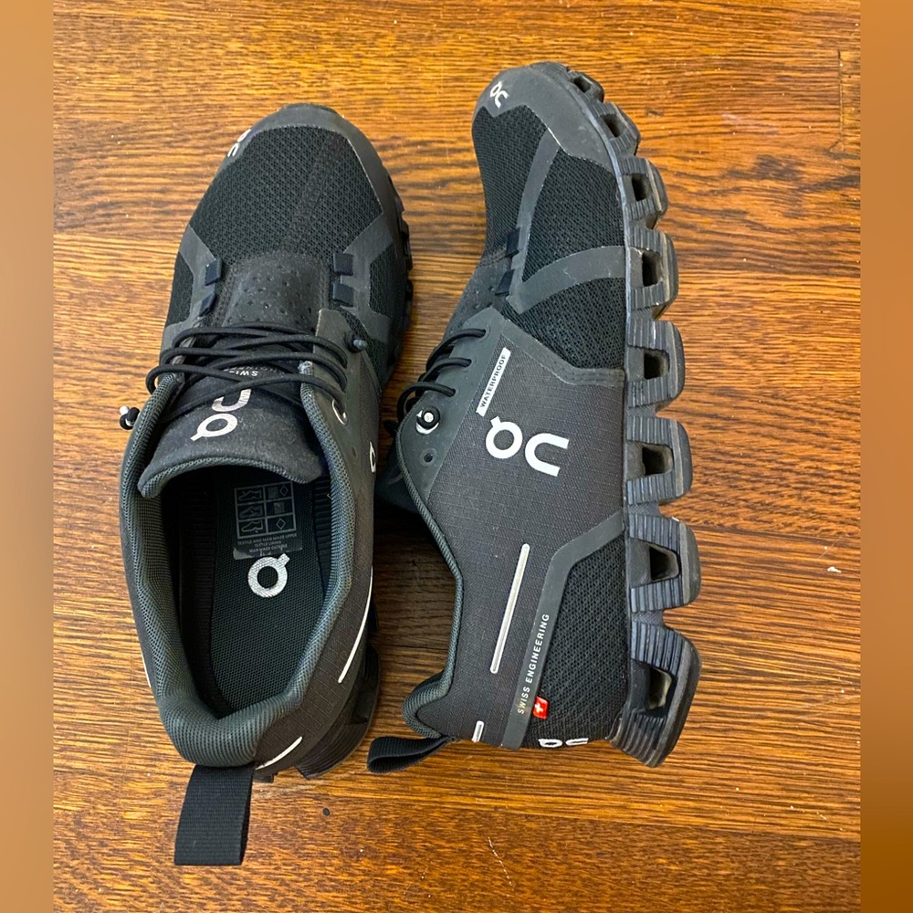 Women's all black waterproof on cloud tennis shoes.